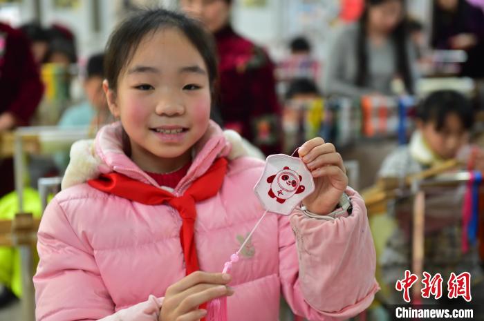 圖為一名小學(xué)生繡制的2022年北京冬奧會(huì)吉祥物“冰墩墩”形象?！∮髟屏?攝