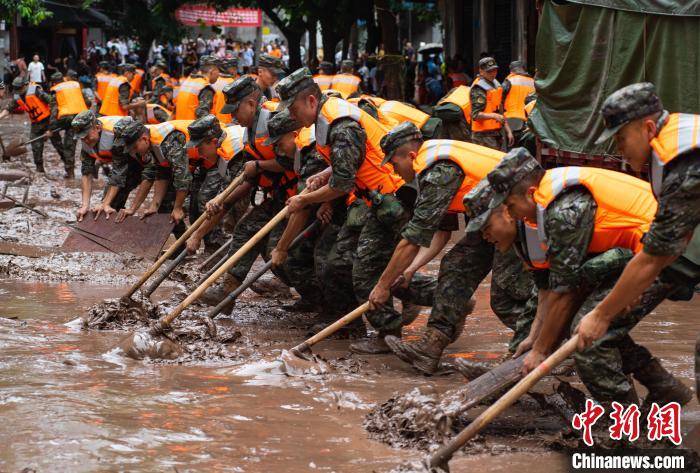 7月4日，萬(wàn)州區(qū)五橋街道，武警官兵清理街道上的淤泥?！∪矫宪?攝