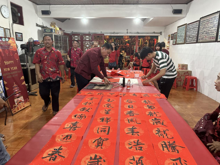 茍皓東為華人朋友現(xiàn)場寫春聯(lián)送福字。巴陵康孔子學(xué)院供圖