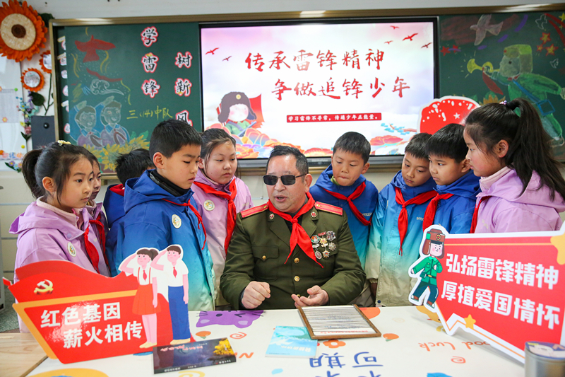 2025年3月3日，江蘇南通如皋市安定小學里，傷殘軍人許波銀在思政小課堂上向?qū)W生講述雷鋒故事。