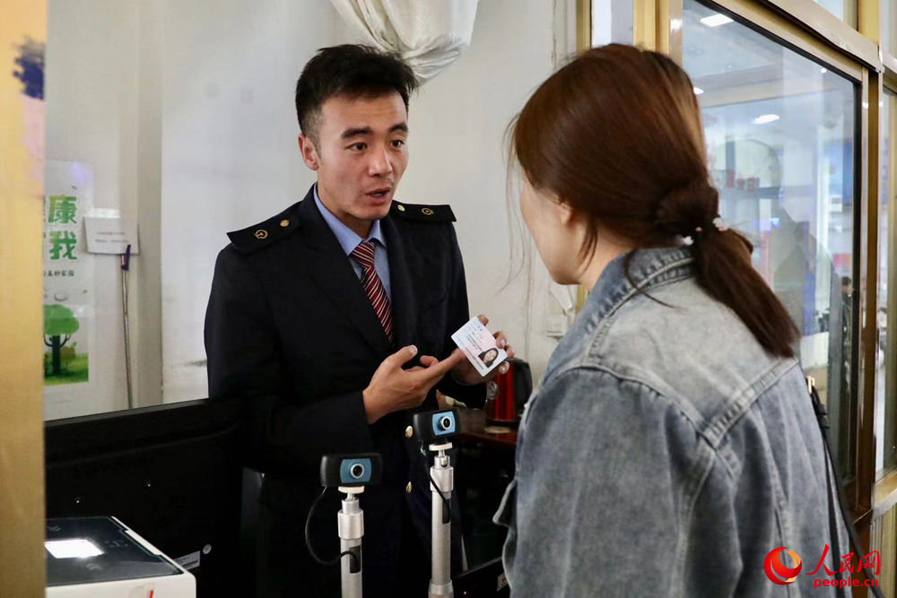 車站工作人員向旅客解答疑問(wèn)。人民網(wǎng)記者 次仁羅布攝